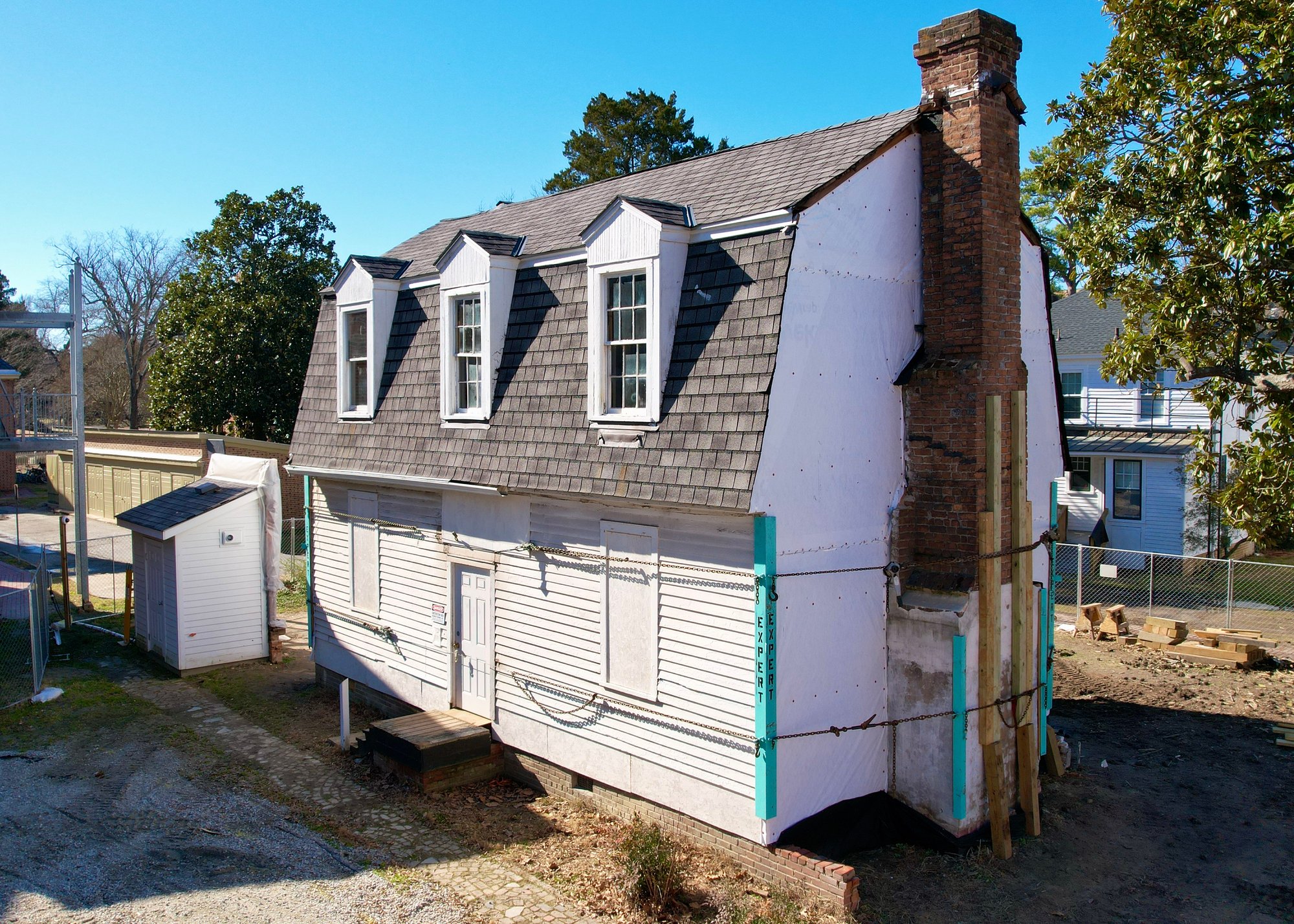 house with damaged chimney being shored