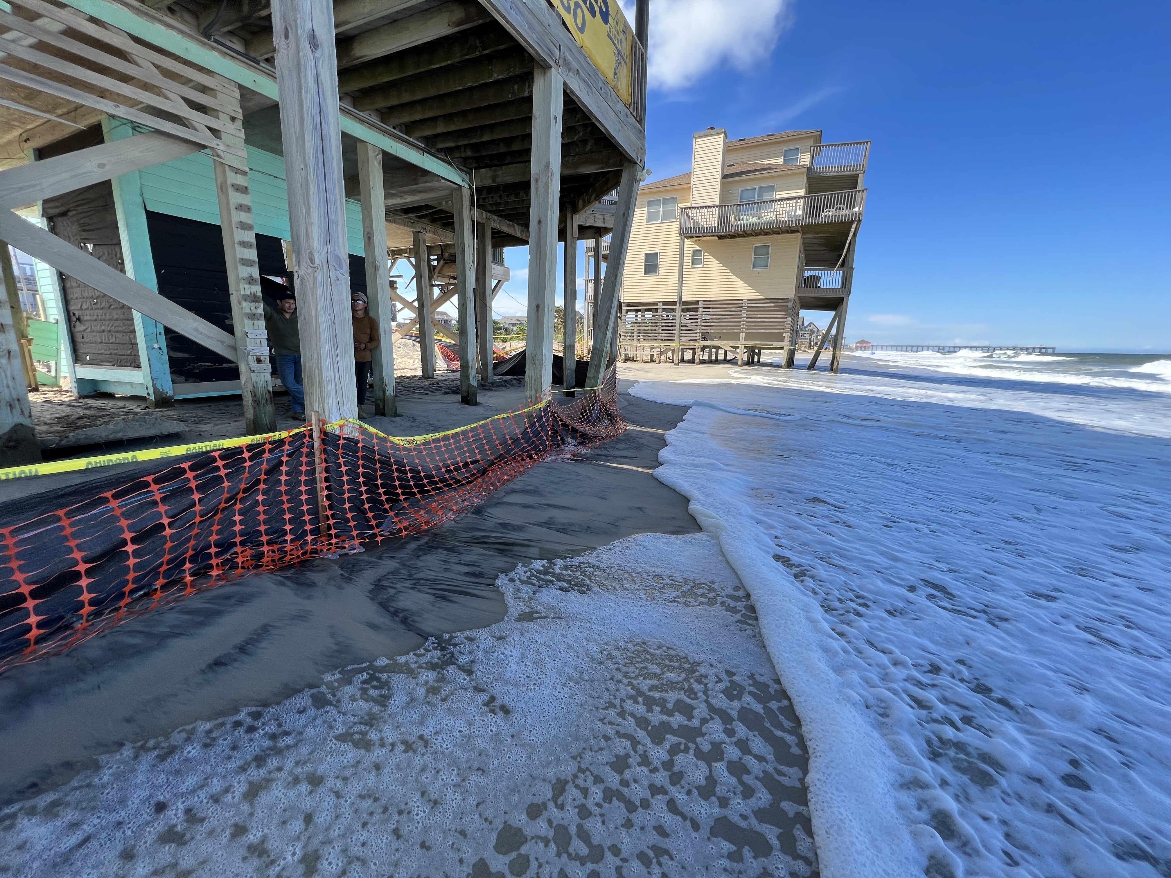 house on beach with water at foundation